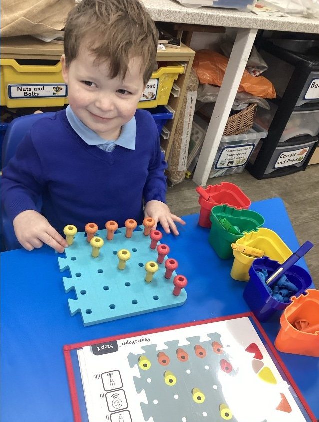 Luke completing his Pegs to Paper 